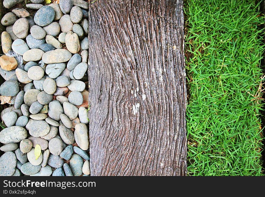 Texture Detail Of Gaden Design With White Gravel, Old Wood And Grass Decoration In Garden