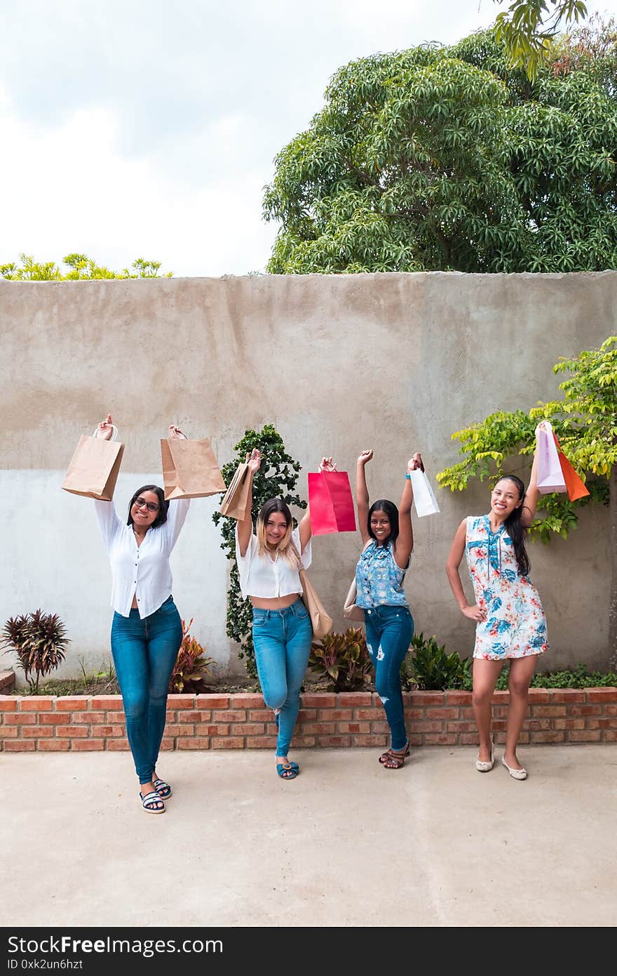 Portrait Of Four Attractive Young Women Shopping