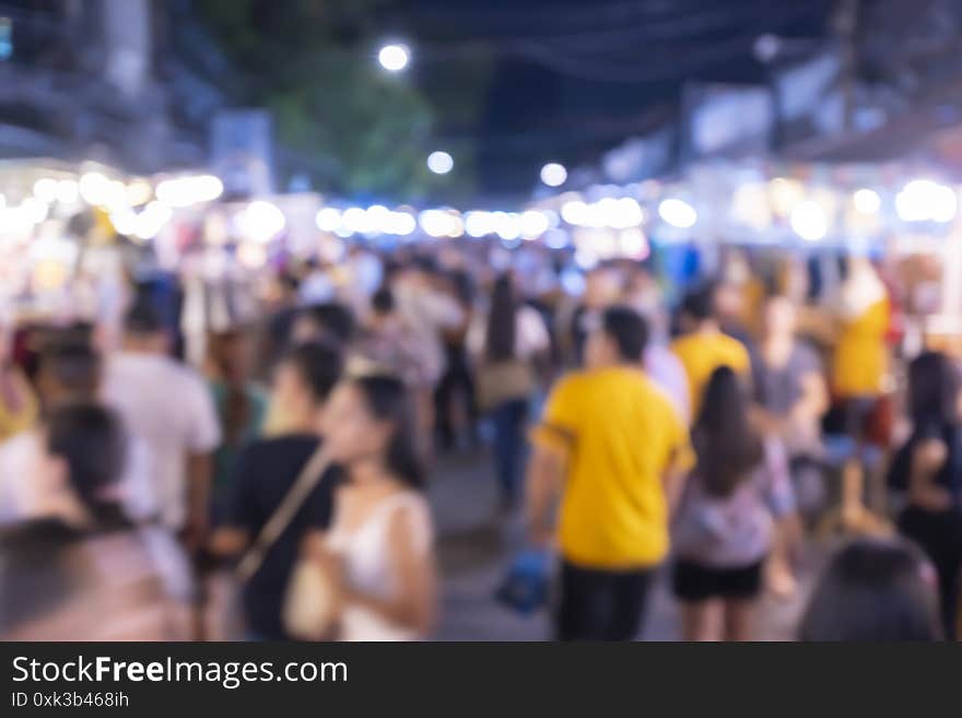 Out of focus picture of a crowd of people walking in the city