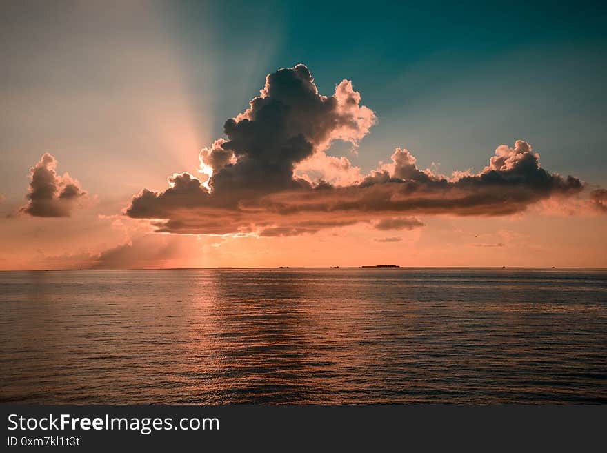 Colourful Sunset In Tropical Islands With Blue Sky Orange Clouds And Sun Rays In Indian Ocean