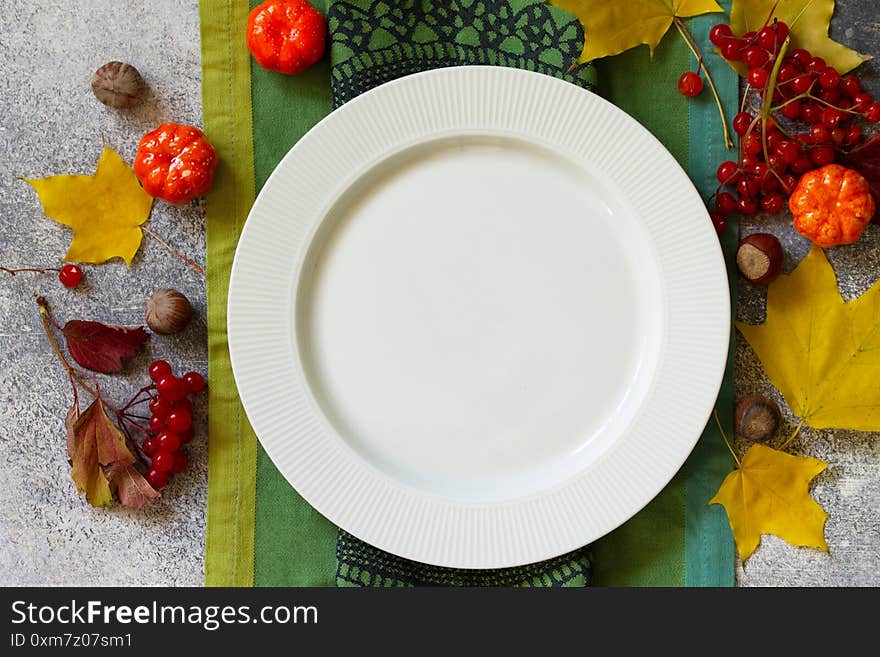 Thanksgiving or autumn harvest table setting on stone or slate table. Top view of a flat lay. Free space for