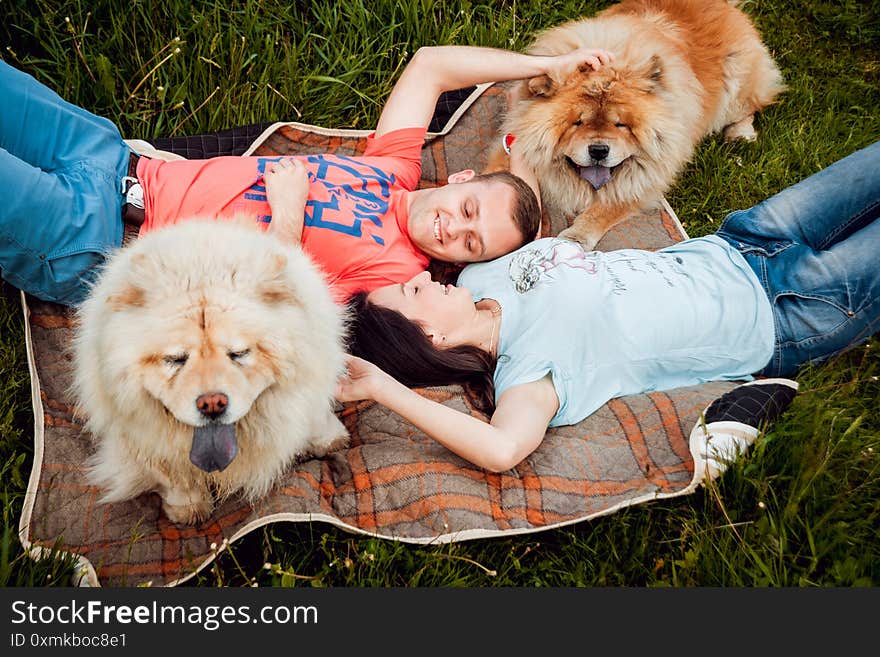 Young couple with the dogs in the park.