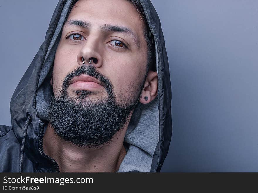 Closeup Shot Of A Male Standing In Front Of A Gray Wall - Concept Of Emotions