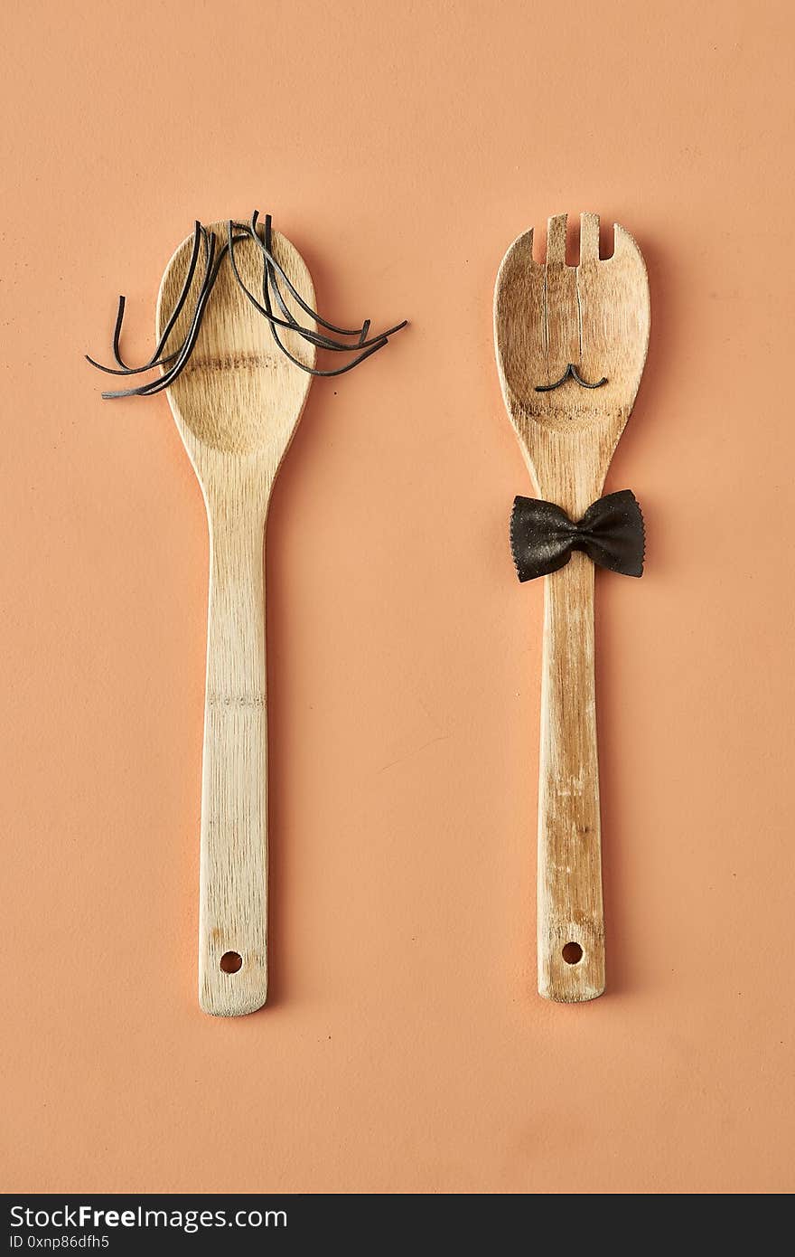 Cartoon Girl And Man Made Up Of Farfalle Pasta And Wooden Spoon, Conceptual Photography For Food Blog Or Ad