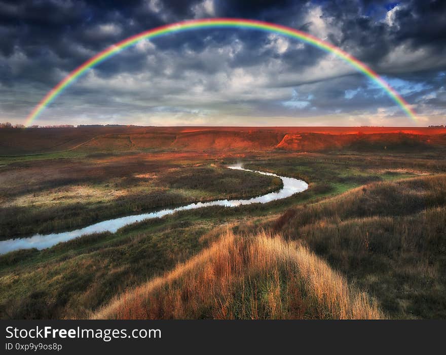 Amazing Rainbow Over The Small Rural River