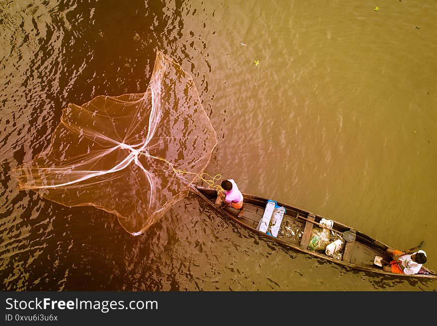 Candid view of mezzo fishing in middle of river, palm tree-fringed, fishing backwaters, Kerala, Malabar Coast, South India, India