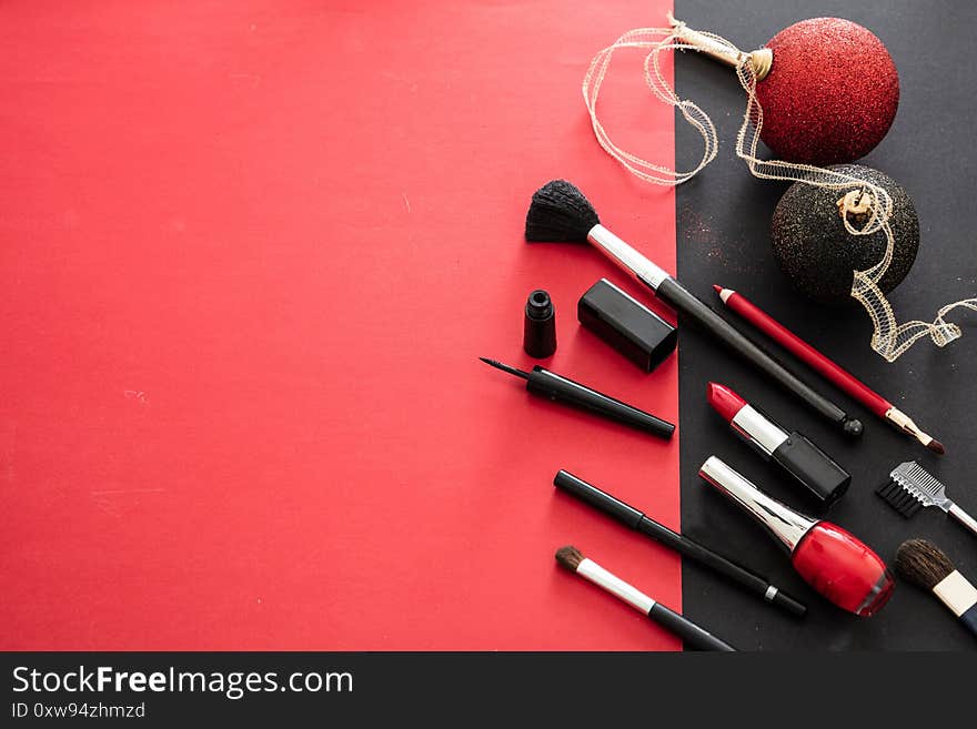 Makeup xmas party concept, red and black flat lay background. Make up products and christmas balls, New years eve preparation. Makeup xmas party concept, red and black flat lay background. Make up products and christmas balls, New years eve preparation