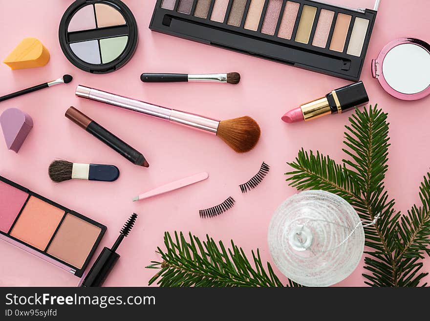 Make up xmas cosmetics products against pink color background