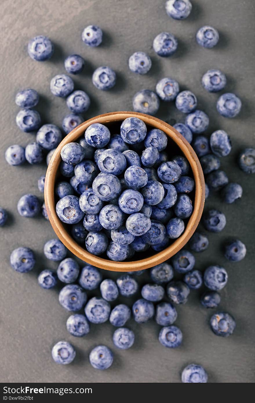 Fresh blueberry in wooden bowl Top view. Concept of healthy and dieting eating, top view