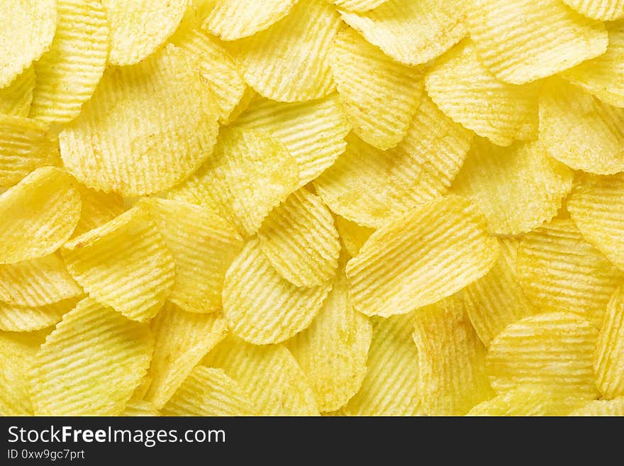 Background corrugated golden chips with texture, top view