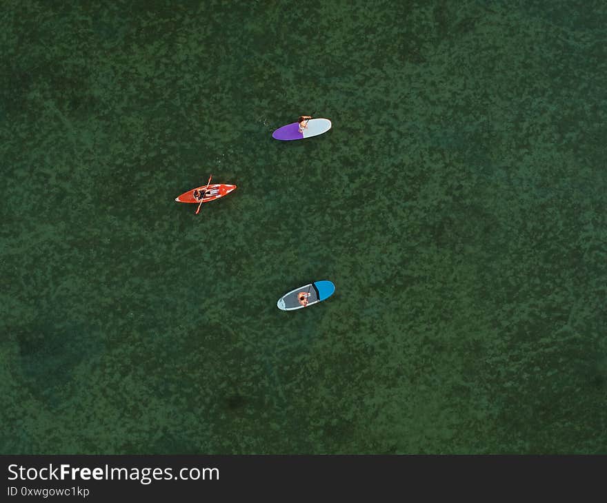 Top view of SUP boards and kayaks on shallow turquoise water of Azov sea, Ukraine