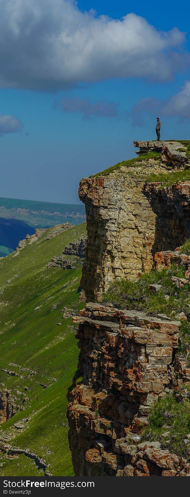 Man Stands On The Abyss At Beautiful Amazing Bermamyt Plateau, Caucasus Elbrus Vertical Panorama