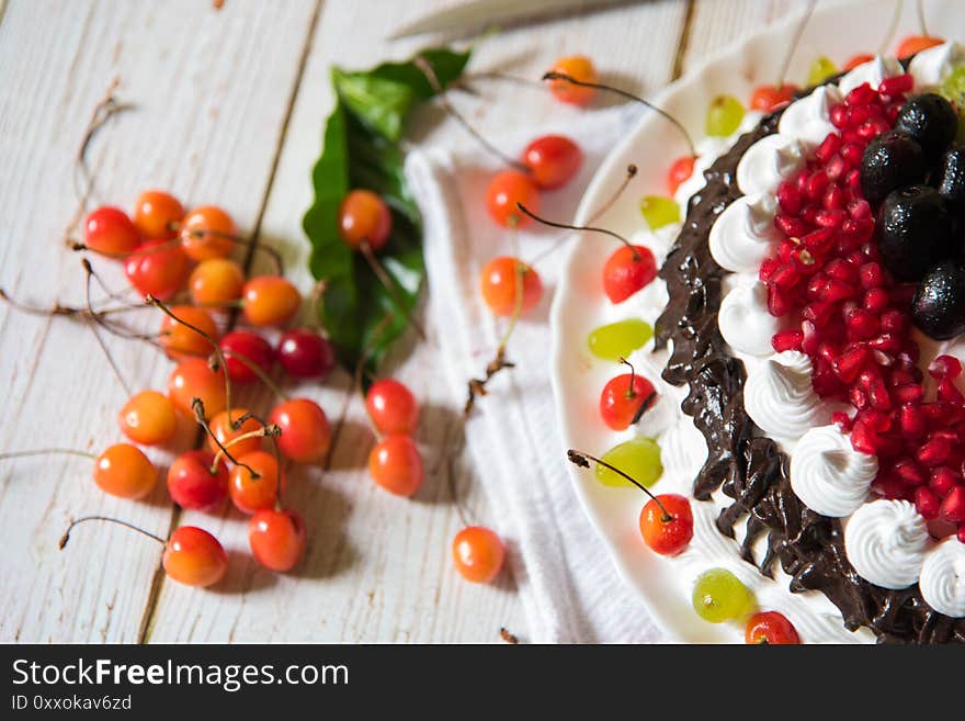 A different angle of view of the cake and cherries on a background. A different angle of view of the cake and cherries on a background