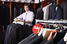 Close-up Of Suits Hanging On Rack With Price Tag In Store Royalty Free Stock Photo