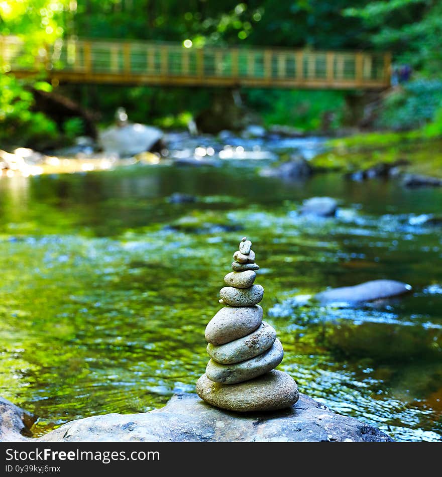 Stone zen, river and suspended wooden brige