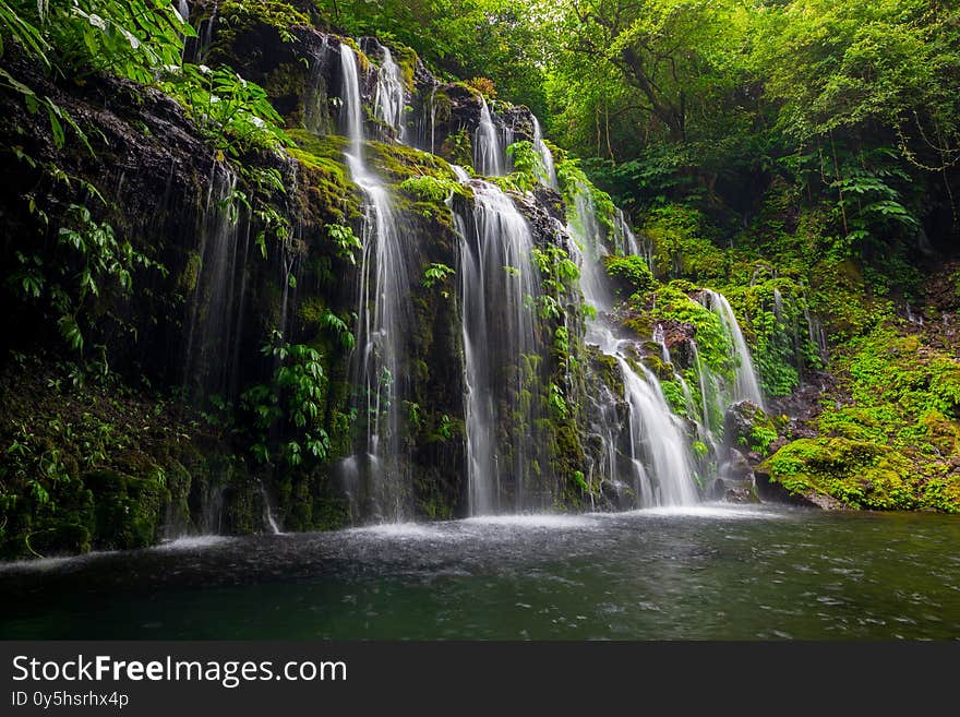 Tropical landscape. Beautiful hidden waterfall in rainforest. Adventure and travel concept. Nature background. Slow shutter speed, motion photography. Banyu Wana Amertha waterfall Bali, Indonesia. Tropical landscape. Beautiful hidden waterfall in rainforest. Adventure and travel concept. Nature background. Slow shutter speed, motion photography. Banyu Wana Amertha waterfall Bali, Indonesia