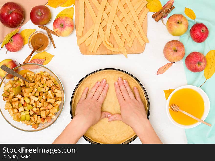 Autumn baking concept. step-by-step recipe for baking a traditional autumn Apple pie, copy the space on a light background. knead the dough and pour the apples into the dough