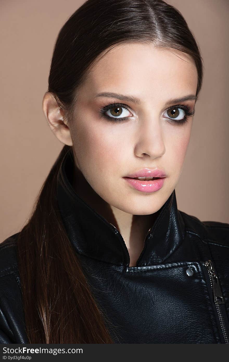 Portrait of girl with brown eyes and brown hair in  leather jacket, big eyes,. Portrait of girl with brown eyes and brown hair in  leather jacket, big eyes,