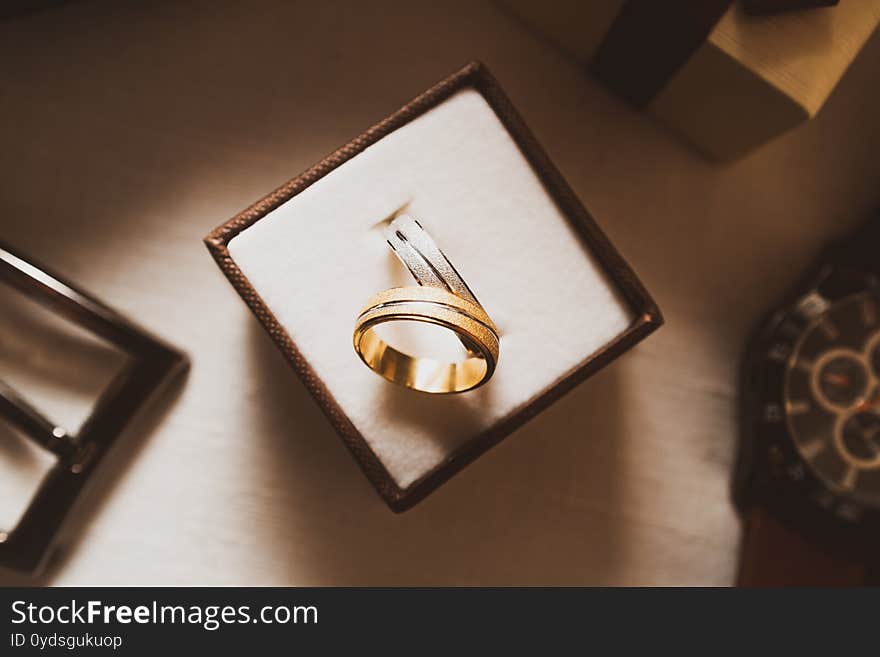 Wedding rings gold and silver in the box top view. Wedding rings gold and silver in the box top view