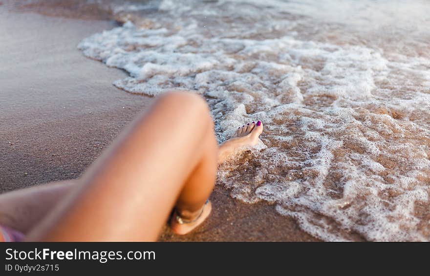 Young Woman Lying On The Beach