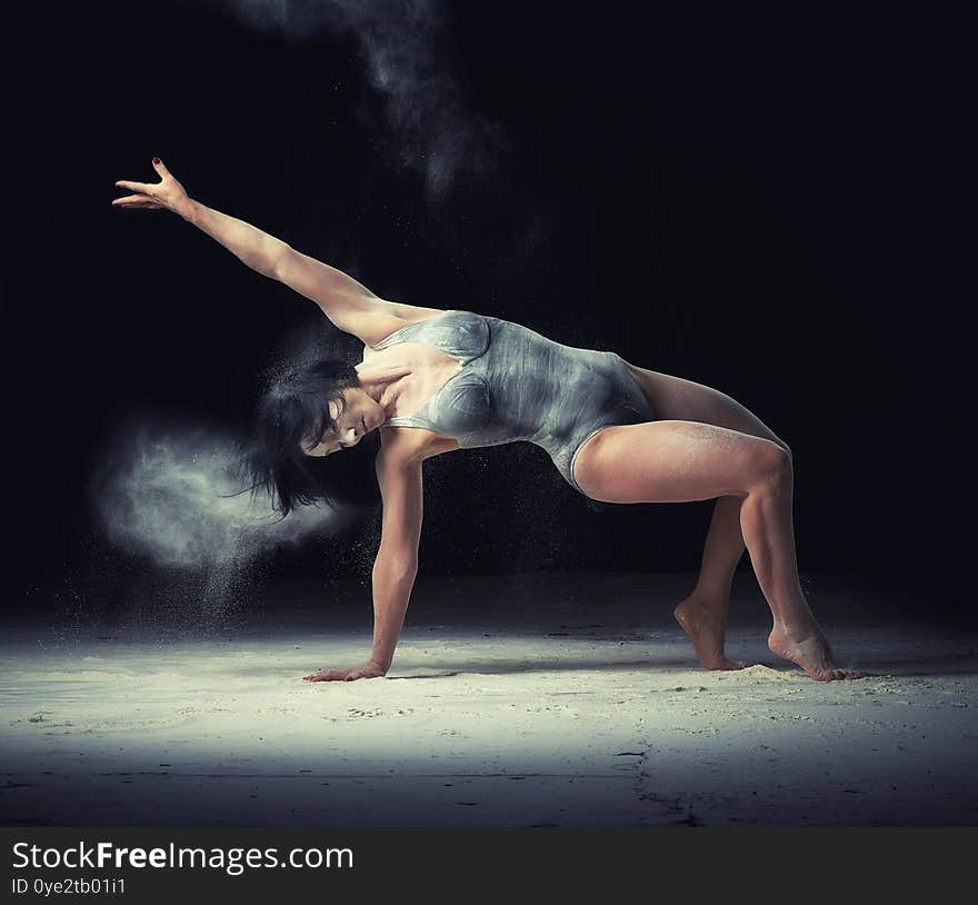 Beautiful Caucasian Woman In A Black Bodysuit With A Sports Figure Is Dancing