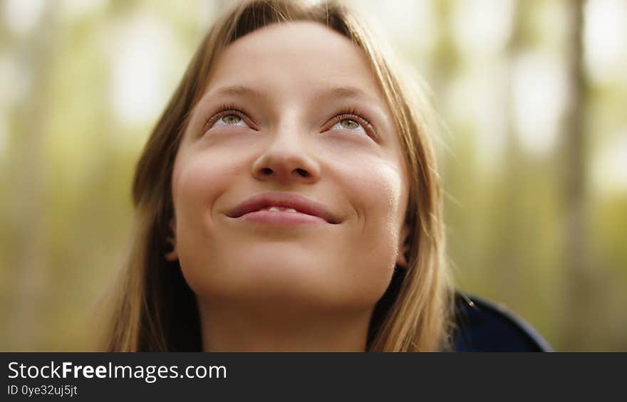 Natural beauty. Young woman with green eyes and toothy smile with no make up in the nature