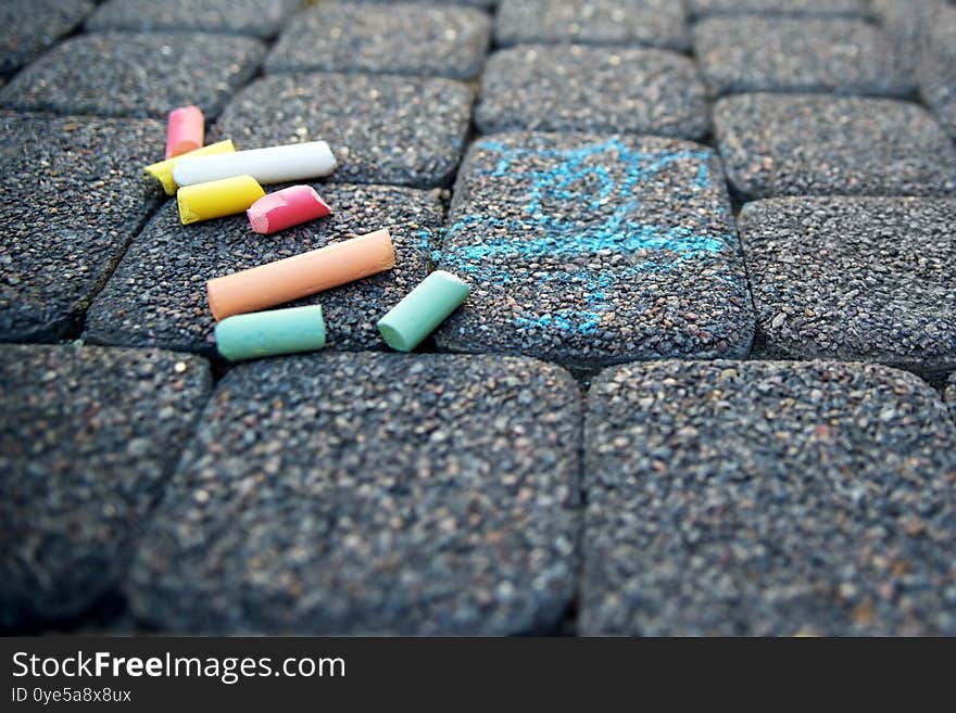 Colorful chalk on asphalt. Children`s multi-colored drawing on the road. children`s drawing with chalk on the asphalt