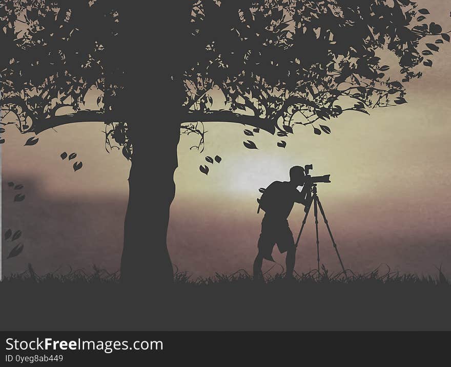 A Photographer Taking Photos Under The Sunset