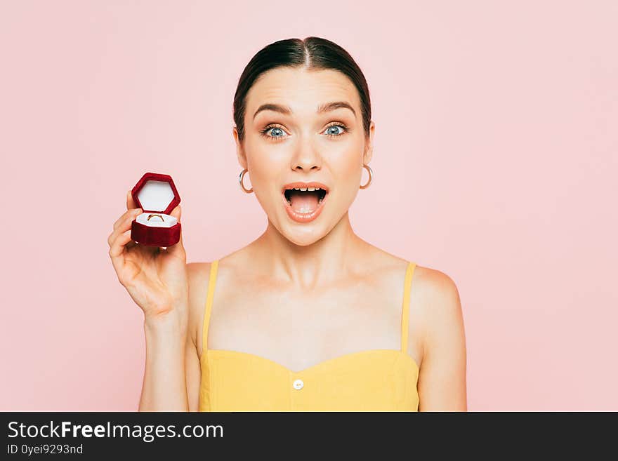 Brunette young woman holding box with