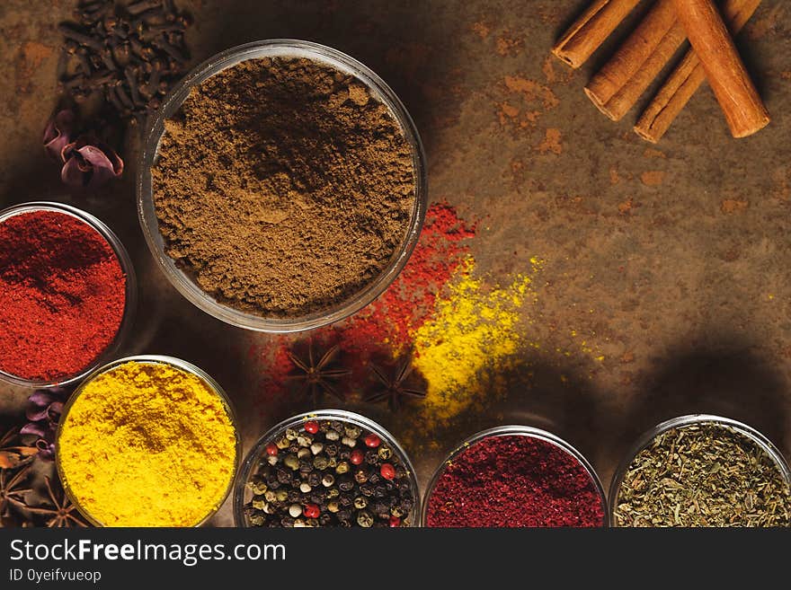 Ground Coriander. Place for text. Different types of Spices in a bowl on a stone background. The view from the top.