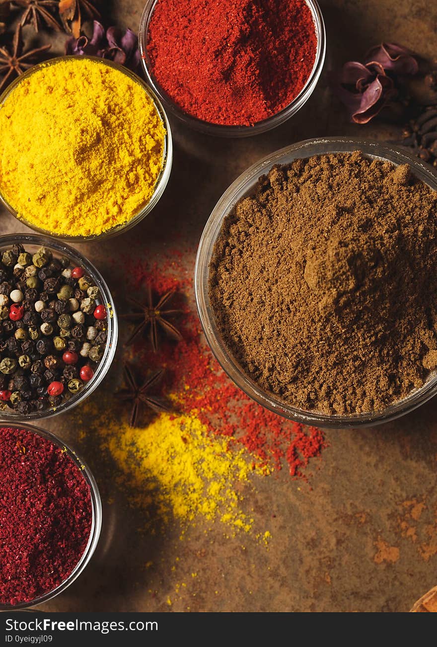 Ground Coriander. Place for text. Different types of Spices in a bowl on a stone background. The view from the top.