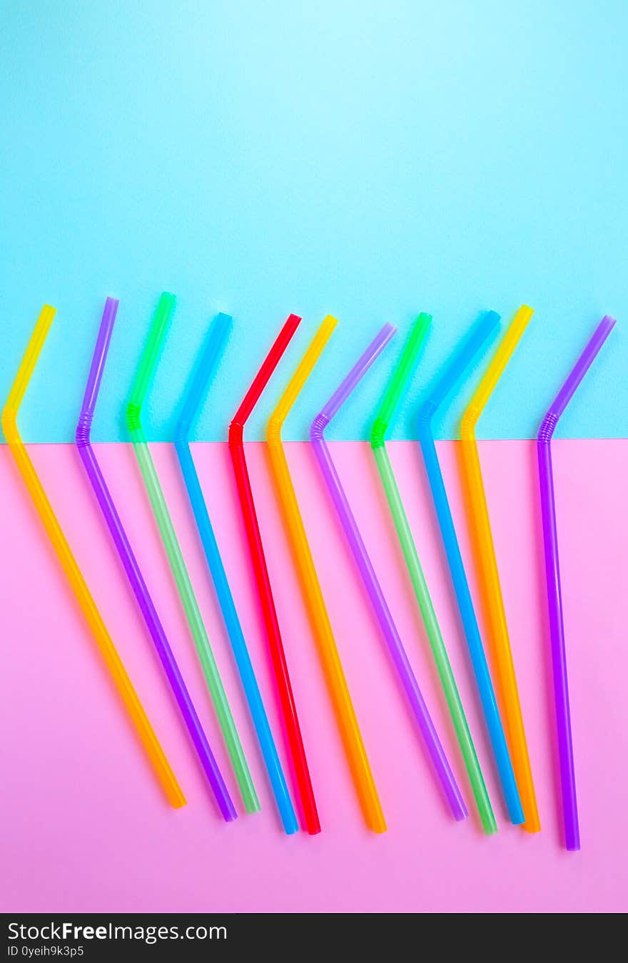 Plastic straws for cocktails. Pastel pink and blue colors. Summer vibes. Hipster party with beverages