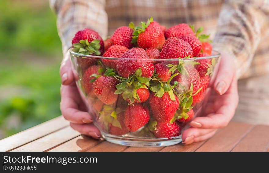 The Woman Put On The Table A Large Bowl With Delicious Ripe Strawberries