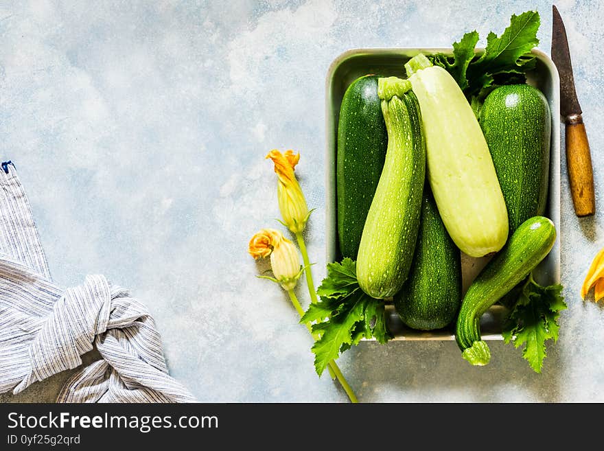 Fresh Raw Zucchini with Edible Flowers in a Pan, copy space for your text. Fresh Raw Zucchini with Edible Flowers in a Pan, copy space for your text