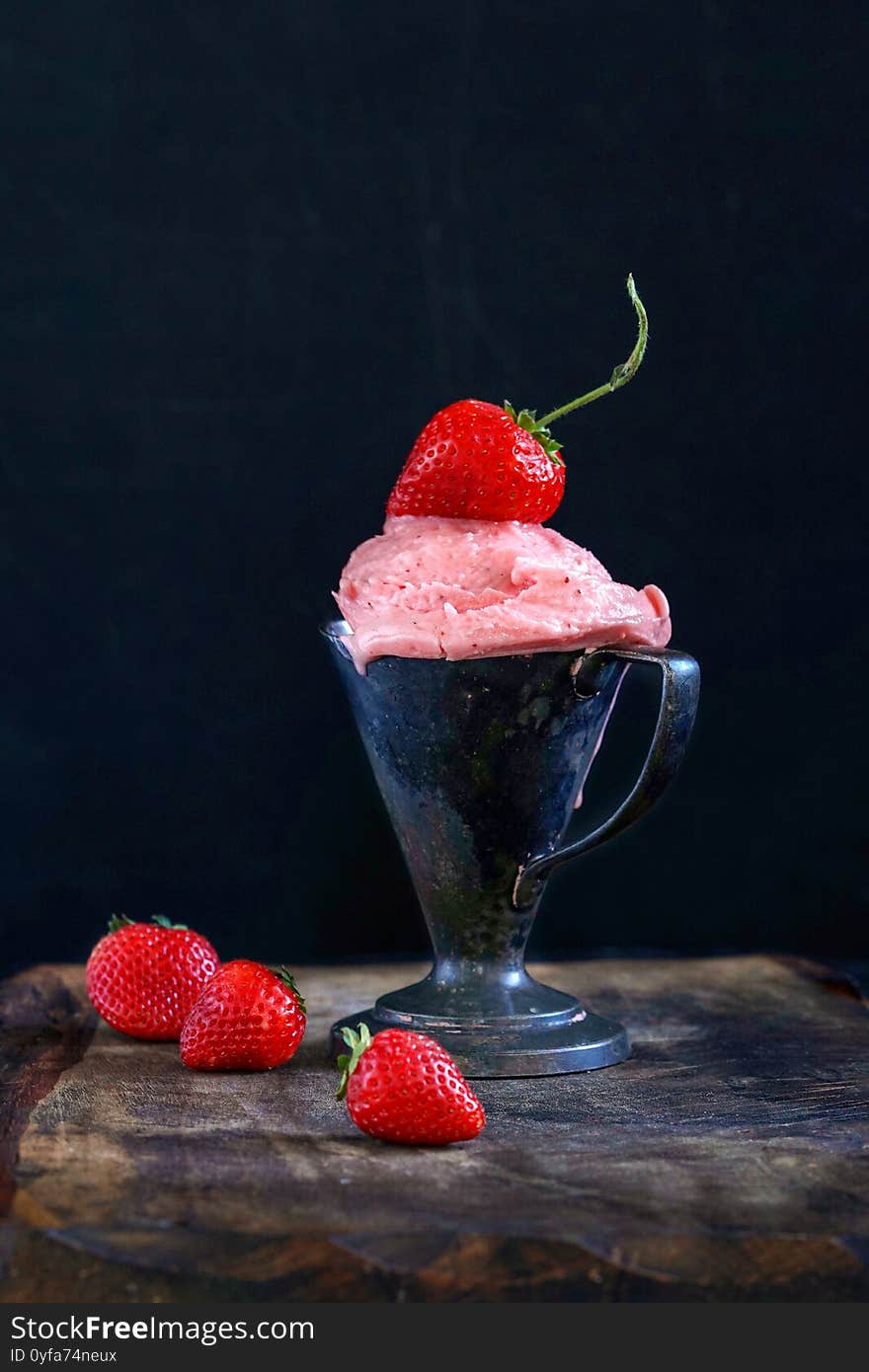 Strawberries ice cream in black background