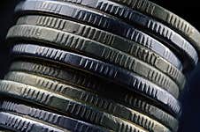 A Stack Of Coins Falls Stock Photo