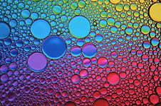 Background Of Colorful Oil Drops In Water Surface Royalty Free Stock Photography