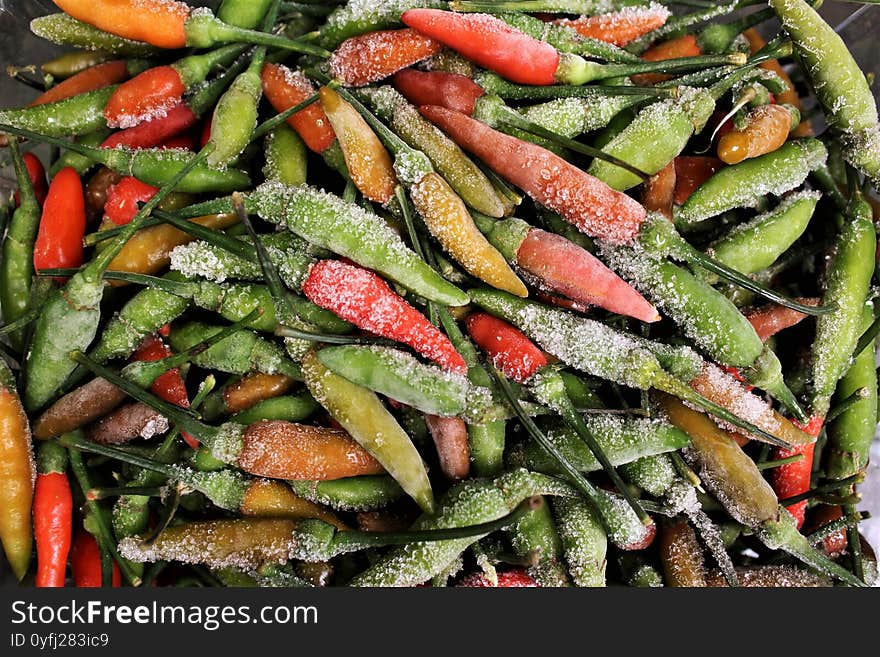 Frozen chili peppers green and red, spicy chili.stock photo background. Frozen chili peppers green and red, spicy chili.stock photo background