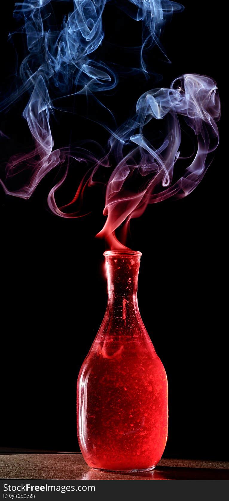 Red bottle with colored smoke