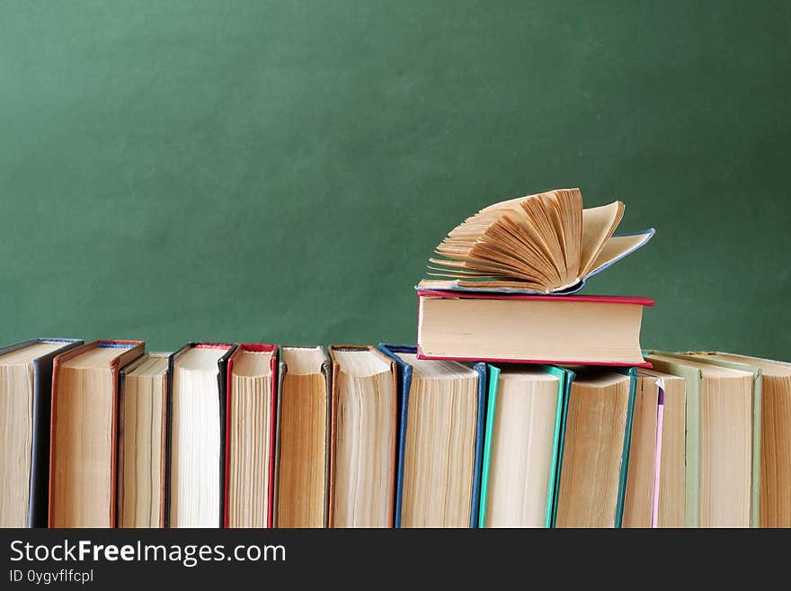 Big Book Pile On Green Background