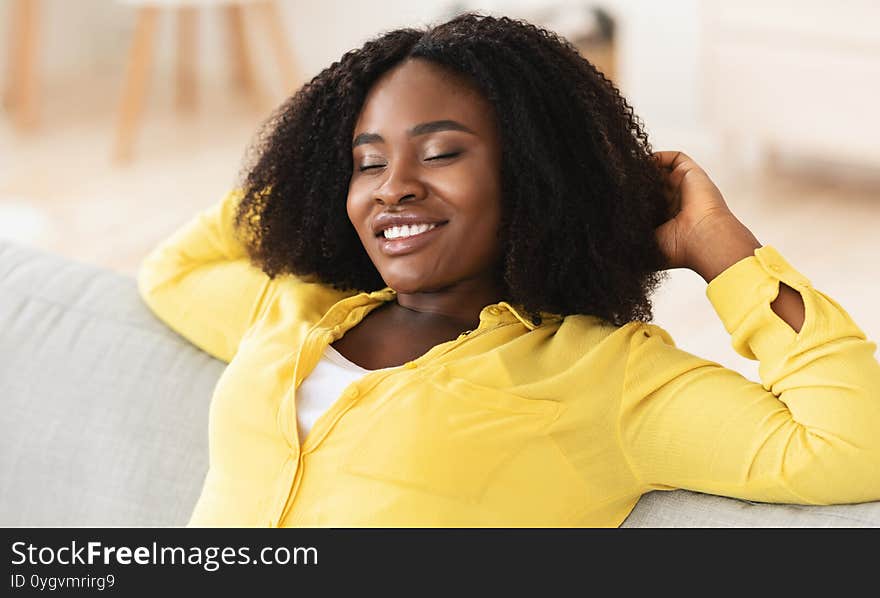 Resting Concept. Close up portrait of black girl relaxing at home on couch with closed eyes, enjoying free time. Resting Concept. Close up portrait of black girl relaxing at home on couch with closed eyes, enjoying free time