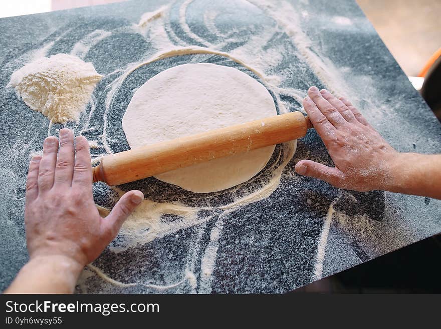 Knead the dough with the ingredients. The chef prepares pizza.