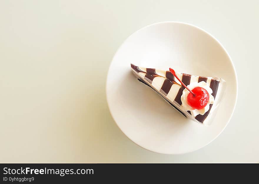 Piece of cake on white dish. Top view