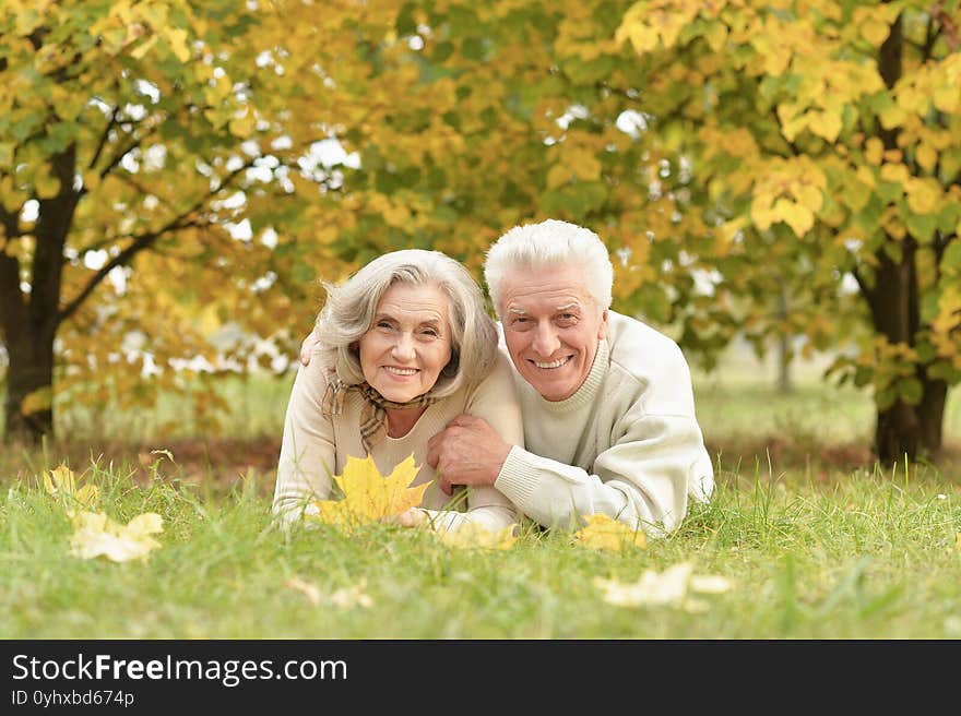 Portrait Of Senior Couple Lying On Grass