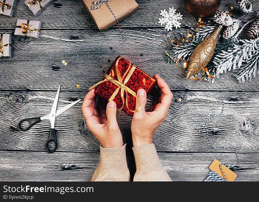 Woman`s hands holding gift box. Christmas background with gift boxes