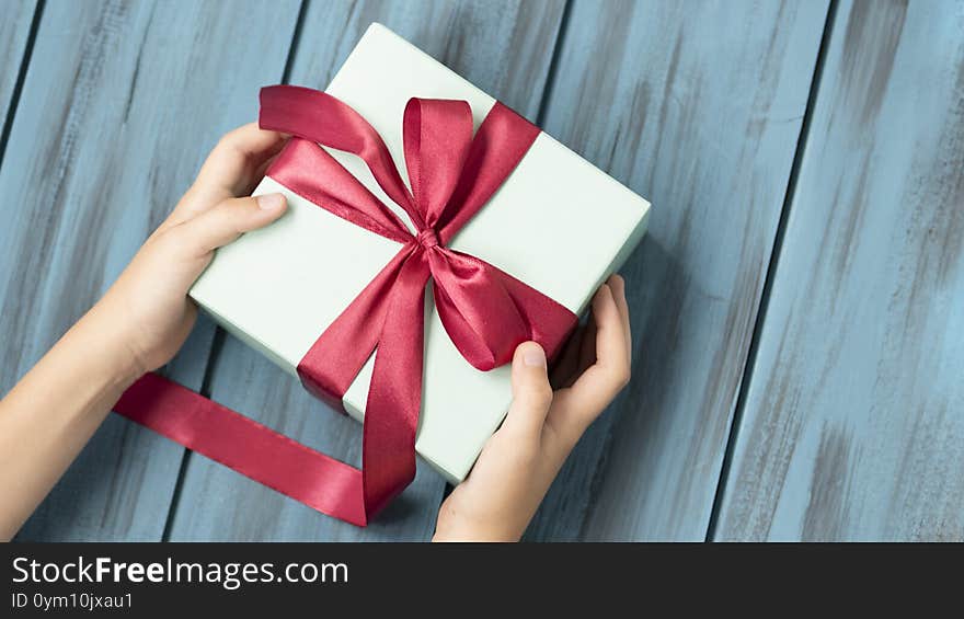 Office delivery service. Cropped shot of businessman at desk with gift box. Copy space