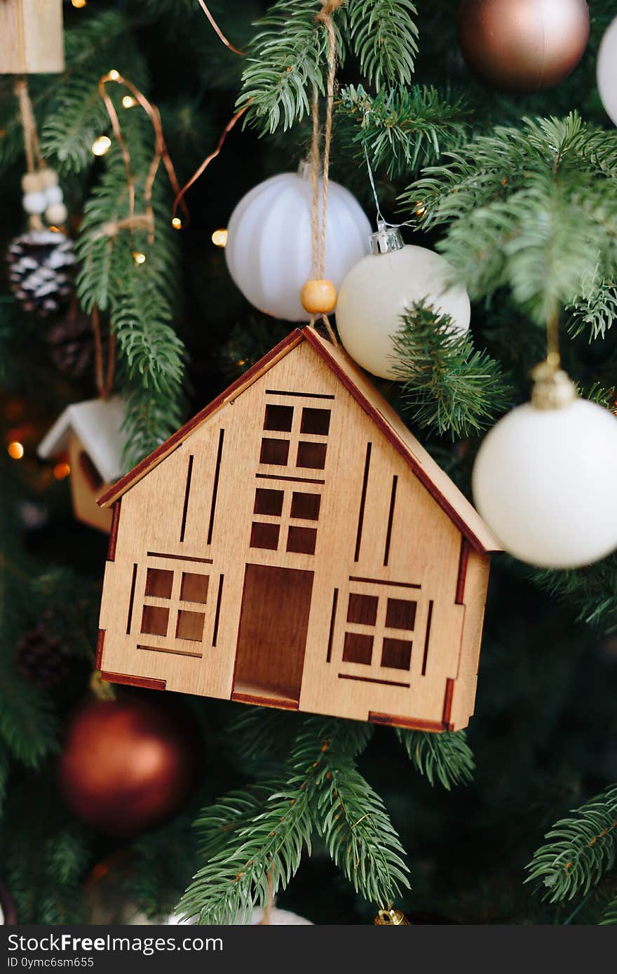 Wooden house Christmas toy on the Christmas tree