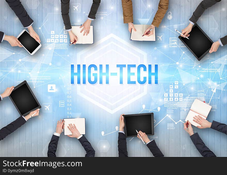 Group of Busy People Working in an Office with HIGH-TECH inscription, modern technology concept. Group of Busy People Working in an Office with HIGH-TECH inscription, modern technology concept