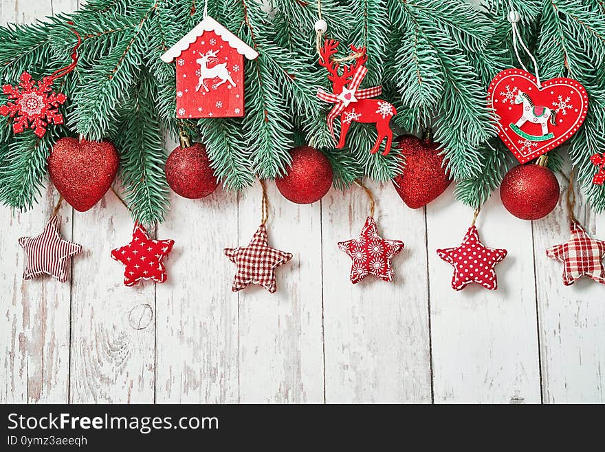 Christmas tree red toys background. Pine branches on white wooden background. Flat lay. Copy space. Happy New Year greeting card.