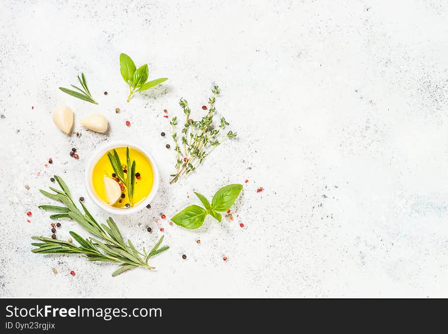 Herbs, spices and olive oil at white kitchen table. Top view, space for text. Herbs, spices and olive oil at white kitchen table. Top view, space for text.